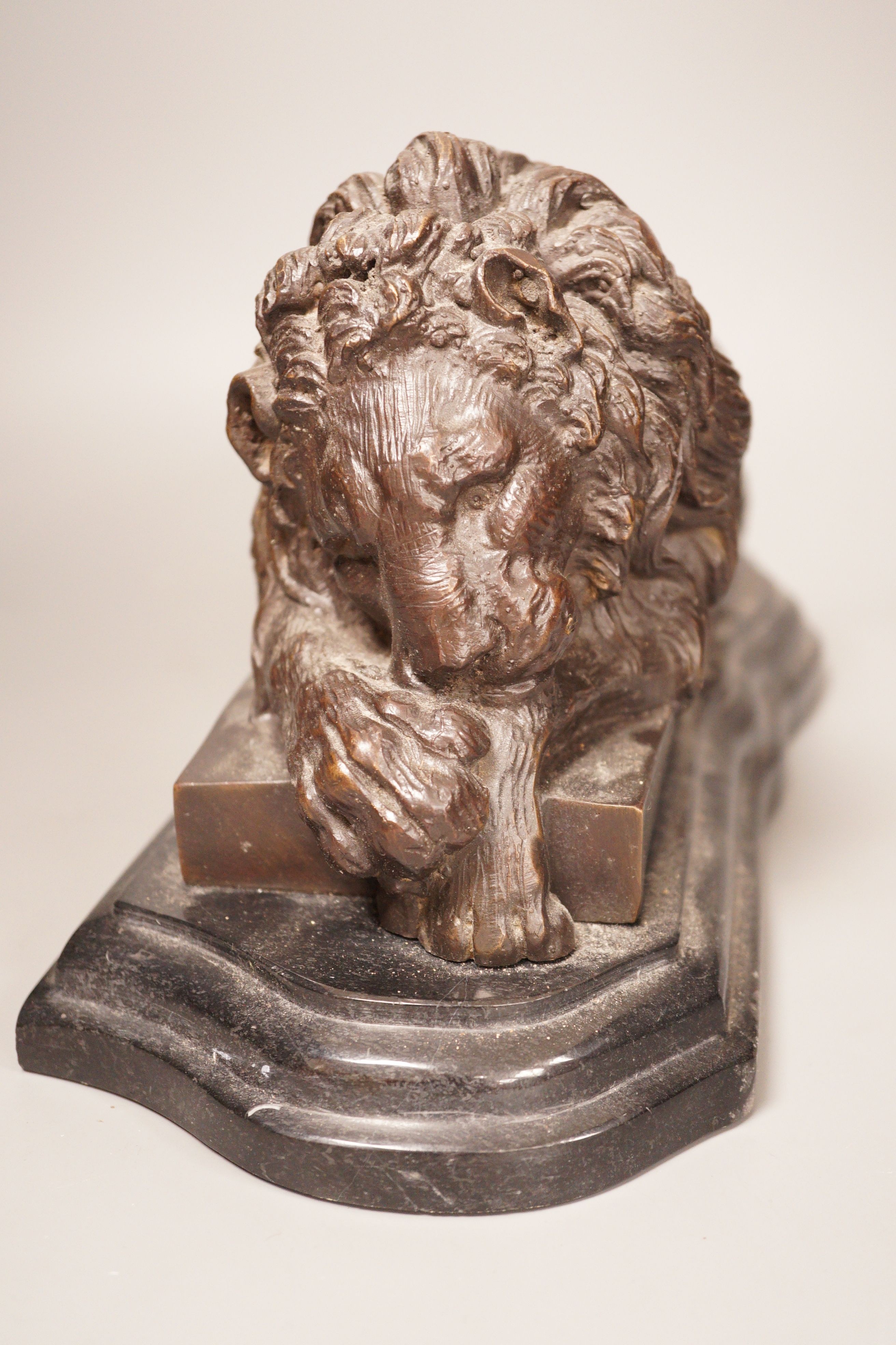 After Isadore Bonheur a bronze figure of a recumbent lion, on marble base, 20th century, 35cm
